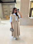 Beige utility vest over white top with matching long maxi skirt