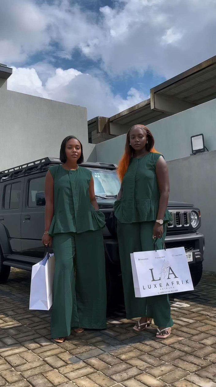 Dark-green twin set with sleeveless peplum top and matching wide-leg trousers