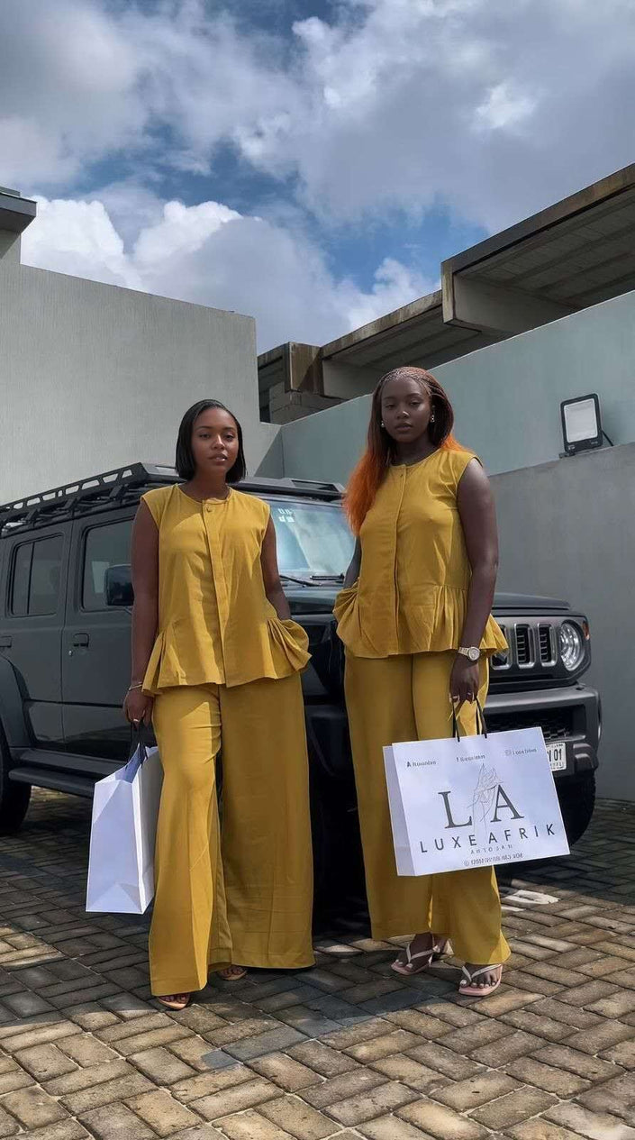 Yellow twin set with sleeveless peplum top and matching wide-leg trousers