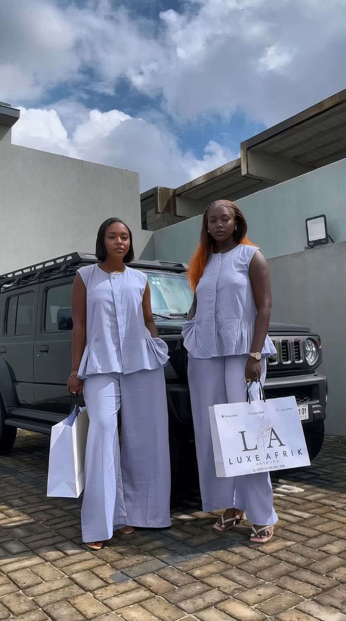 Sky-blue twin set with sleeveless peplum top and matching wide-leg trousers