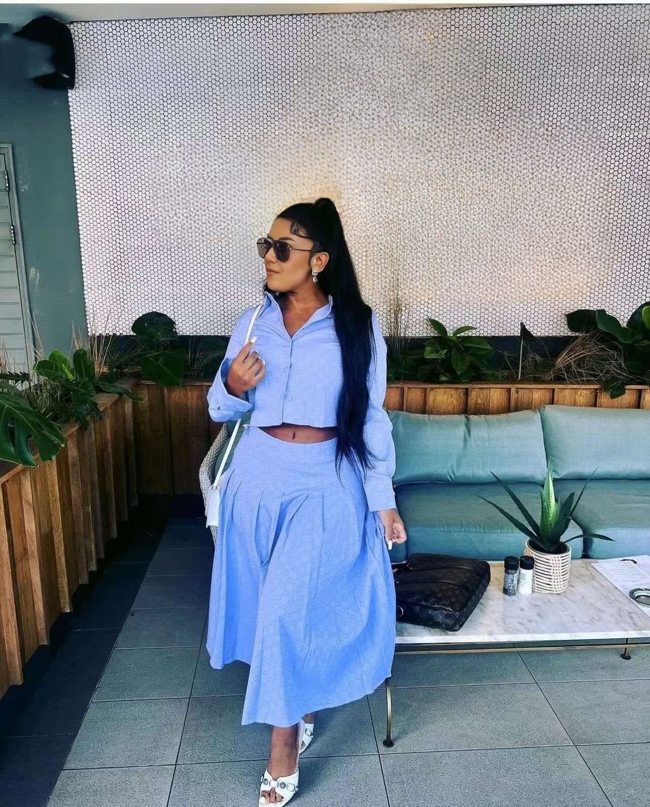 Light blue pleated maxi skirt with tiered fullness and elastic waistband