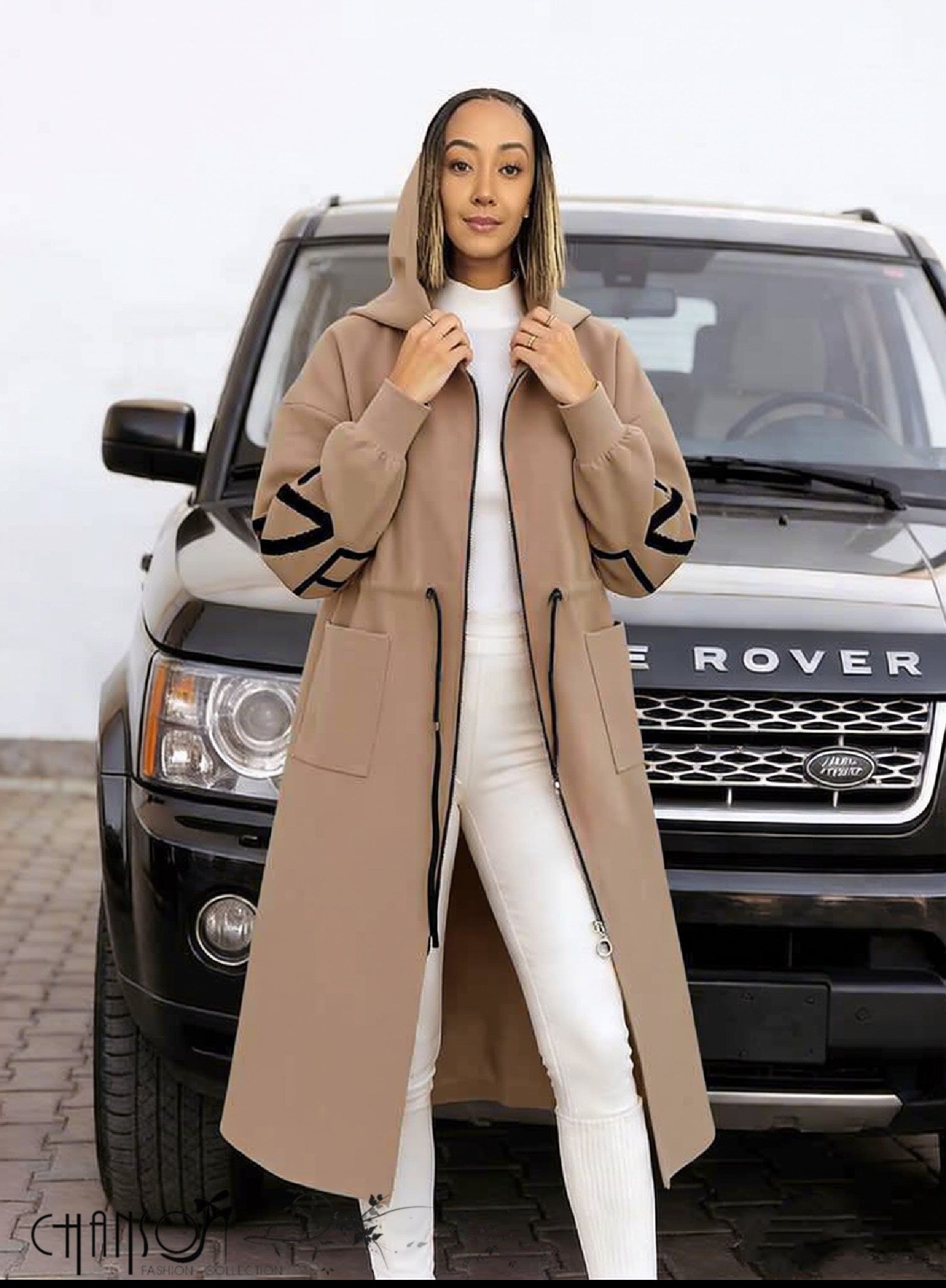 Nude hooded knit coat with front zipper, long length and geometric sleeve trim