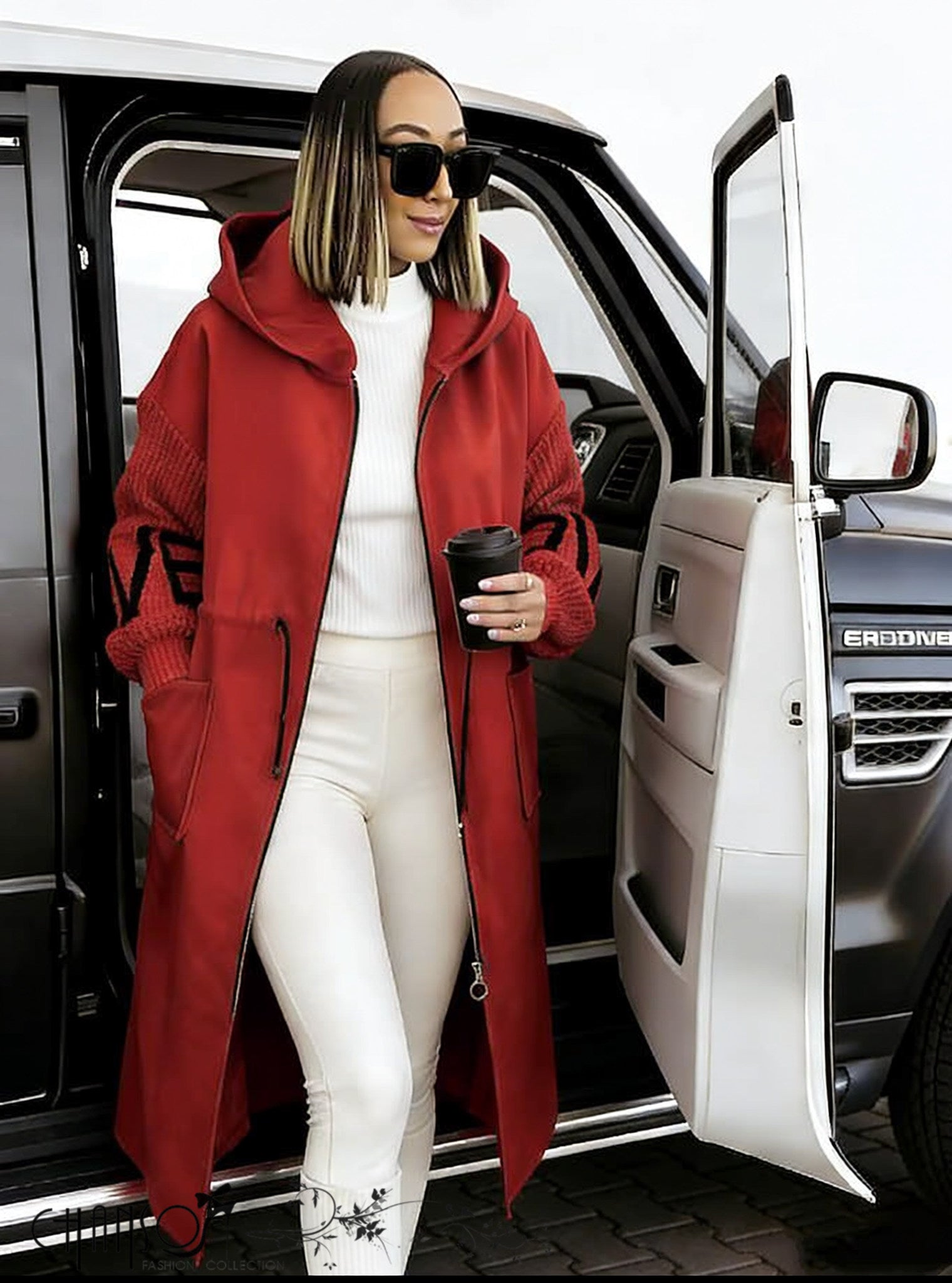 Red hooded knit coat with front zipper and geometric sleeve detailing, long length