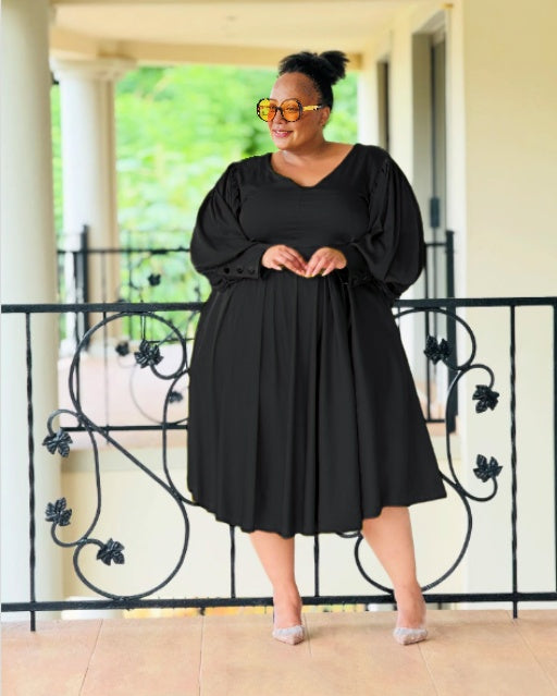 Plus-size midi dress in black with puff sleeves and gathered pleats
