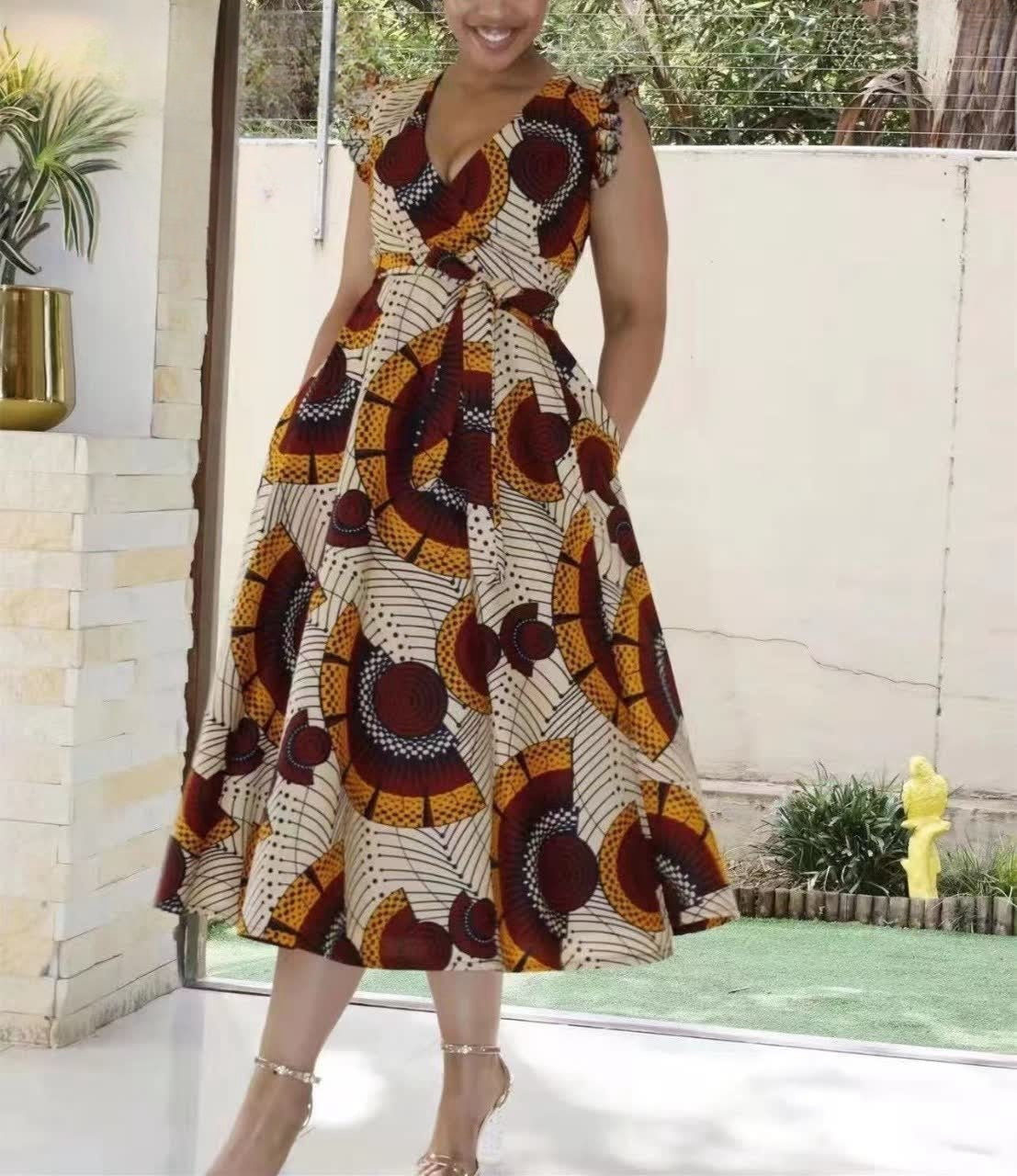 Sleeveless V-neck A-line midi dress with bold African print circles and blocks