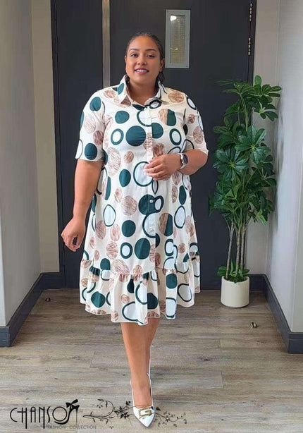 Plus-size shirt dress with white base and teal/brown dots, collared button placket