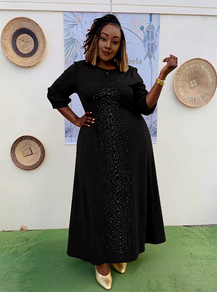 Black plus-size evening dress with shiny beaded embellishment and puff sleeves