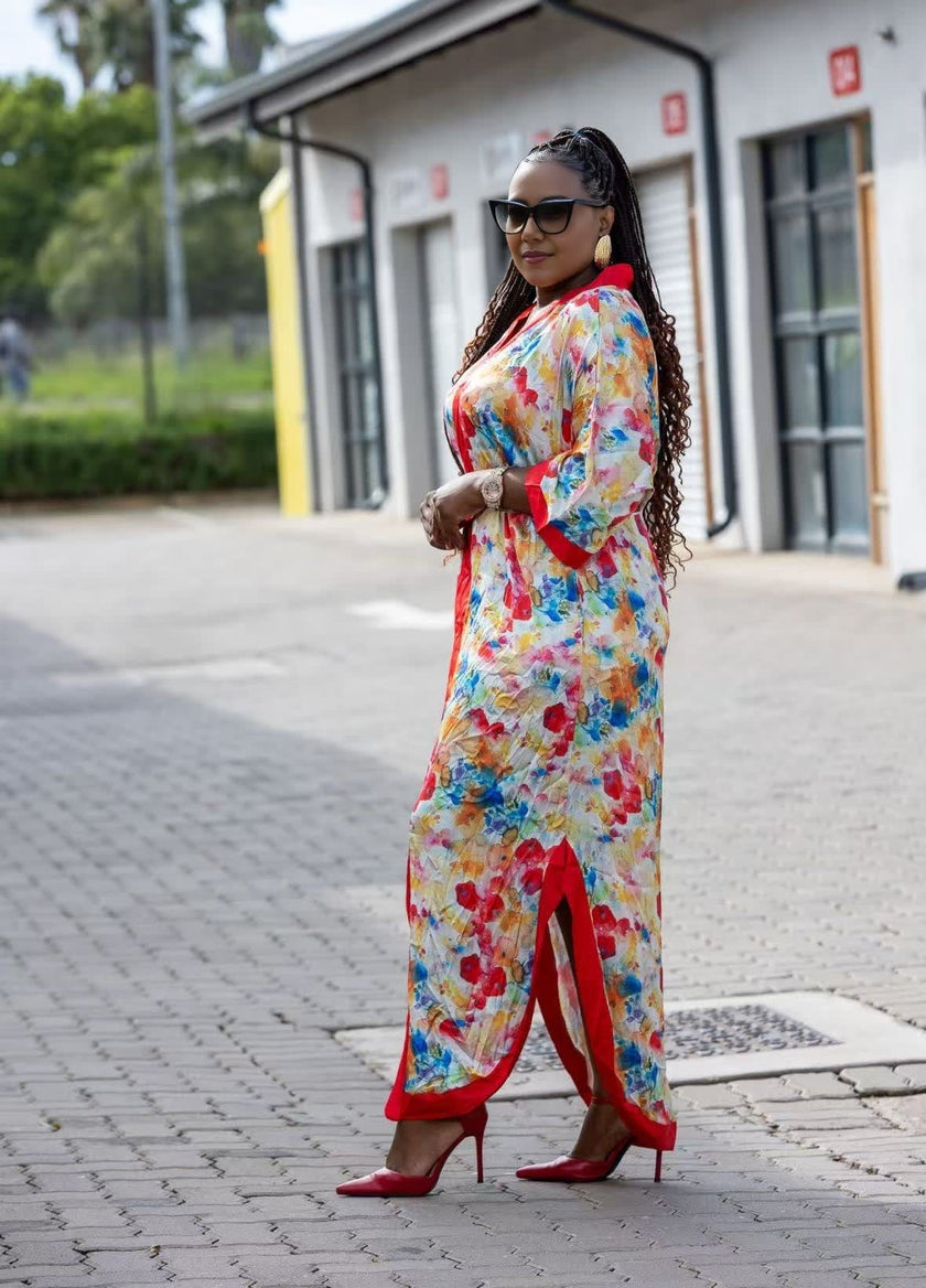 Floral maxi dress with red trim, long sleeves, side slit, full-length front view