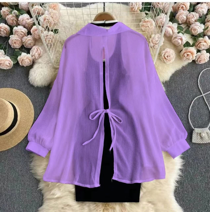 Purple blouse overlay with long sleeves and tie-front cutout over black bodycon dress
