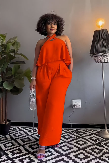 Sleeveless cross-neck jumpsuit with layered ruffle bodice, vivid orange-red