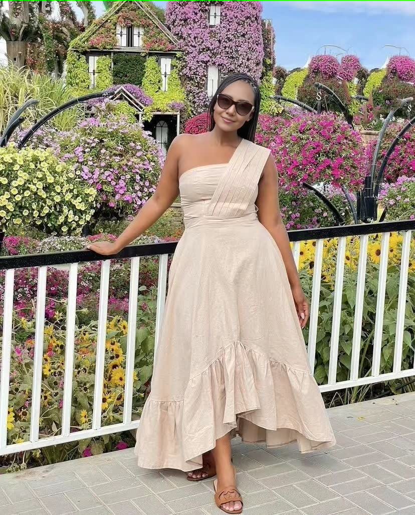 One-shoulder midi dress in beige with ruffle hem and fitted bodice