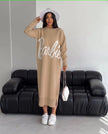 Beige knit maxi dress with long sleeves, round neck, and large script logo