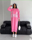 Pink knit maxi dress with long sleeves, round neck, and large script logo