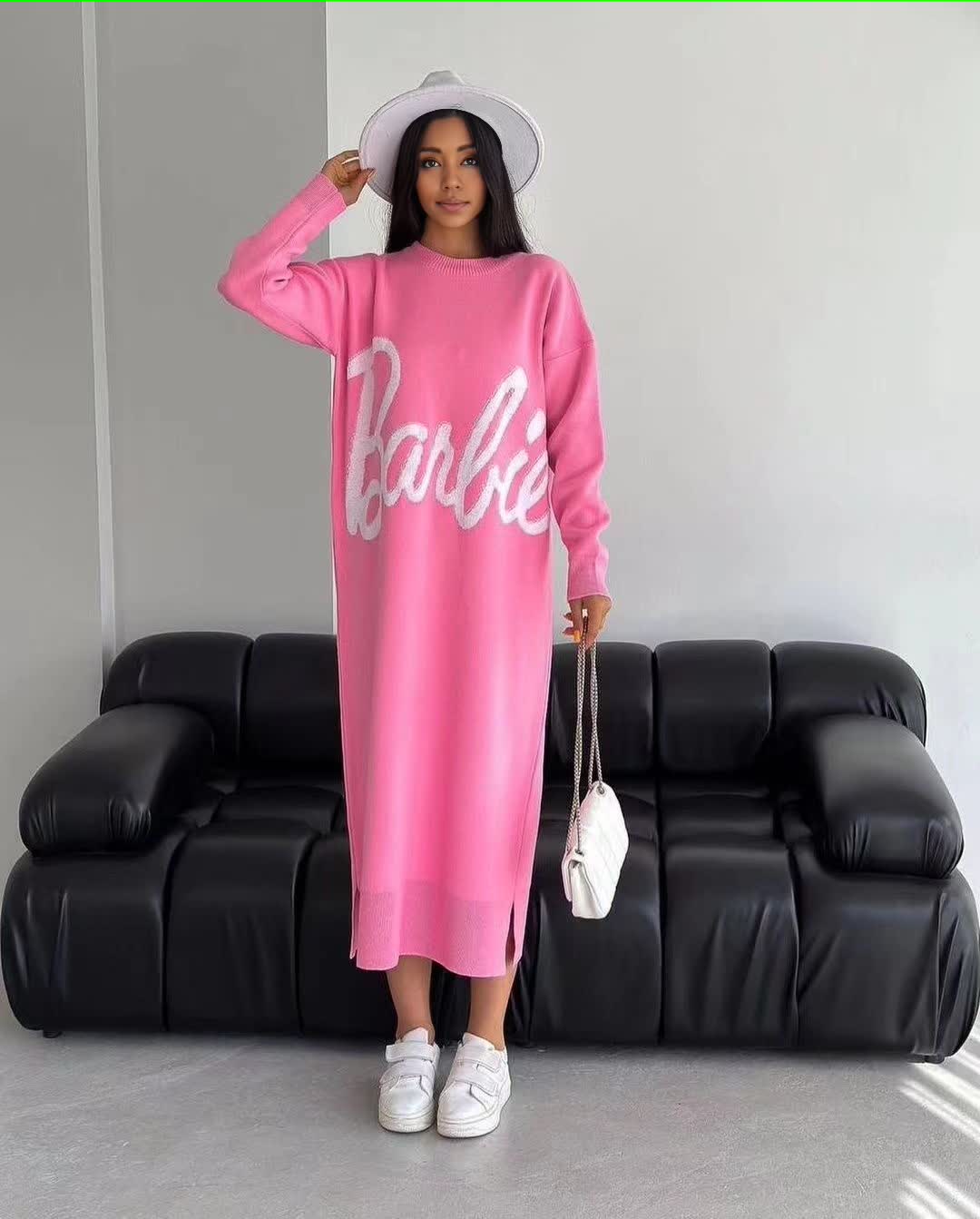 Pink knit maxi dress with long sleeves, round neck, and large script logo