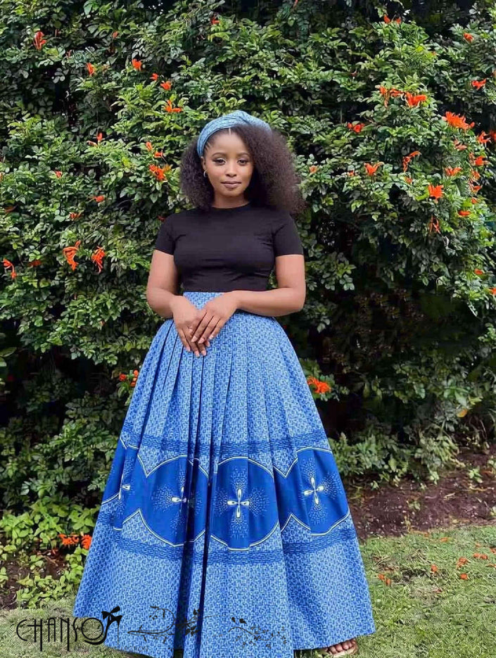 Blue pleated maxi skirt with African print flared panels and patterned hem