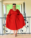 Plus-size midi dress in red with puff sleeves and pleated waist