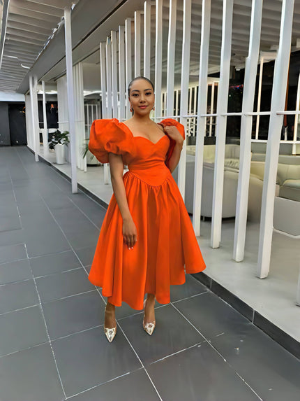 Orange puff-sleeve midi dress with scoop neckline and gathered skirt
