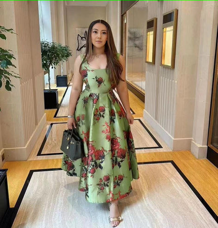 Floral green midi dress with adjustable spaghetti straps and bow-tied waist