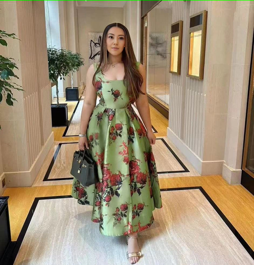 Floral green midi dress with adjustable spaghetti straps and bow-tied waist