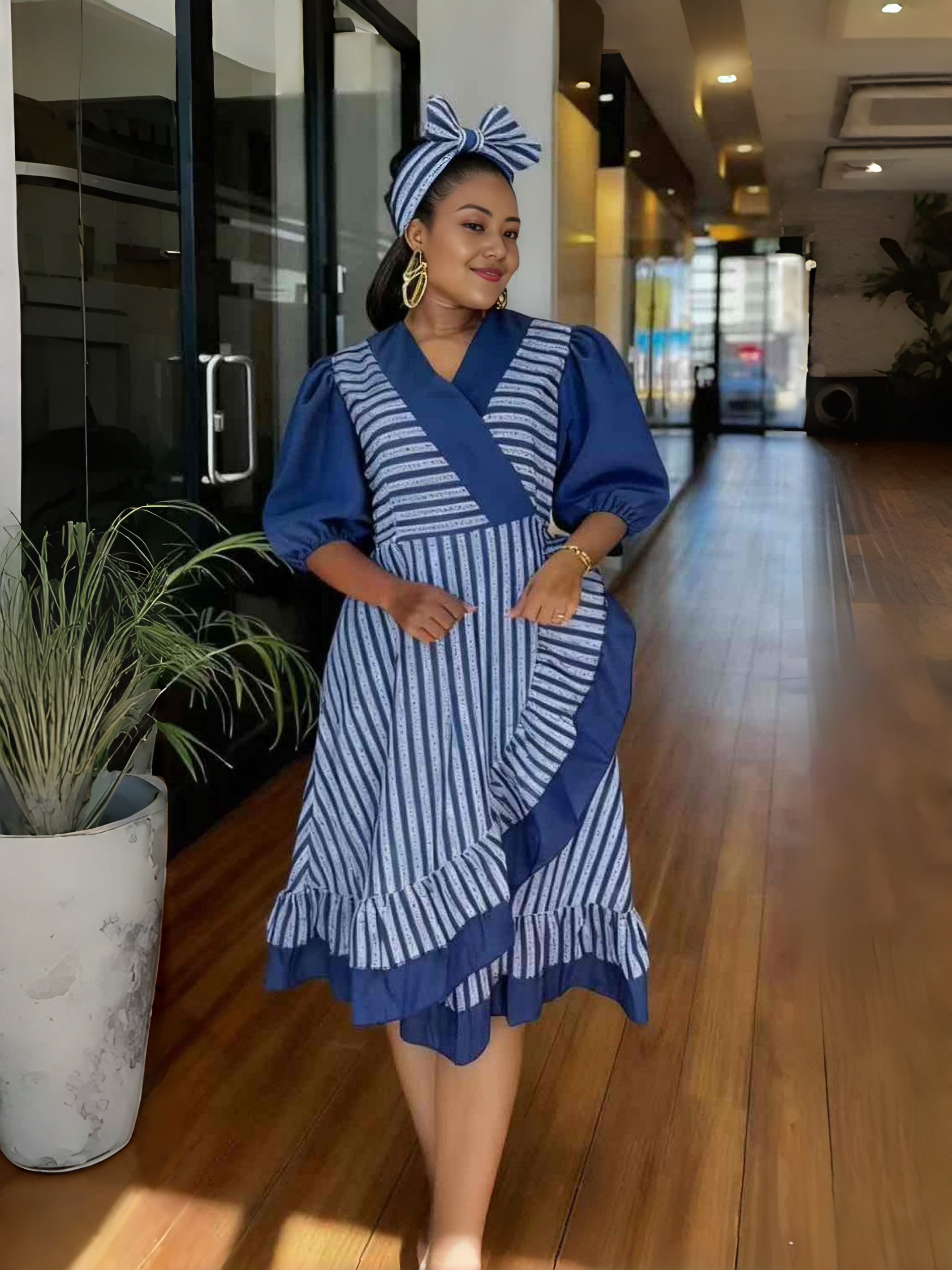 Blue striped wrap dress with puff sleeves and ruffle hem, knee length