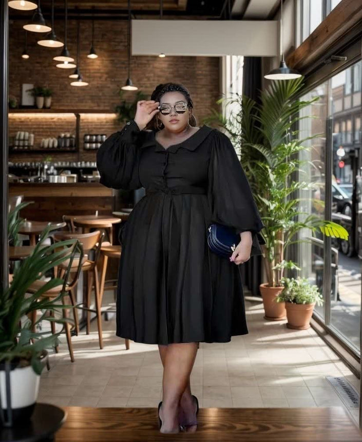 Black midi dress with puff sleeves, gathered waist, and flared skirt