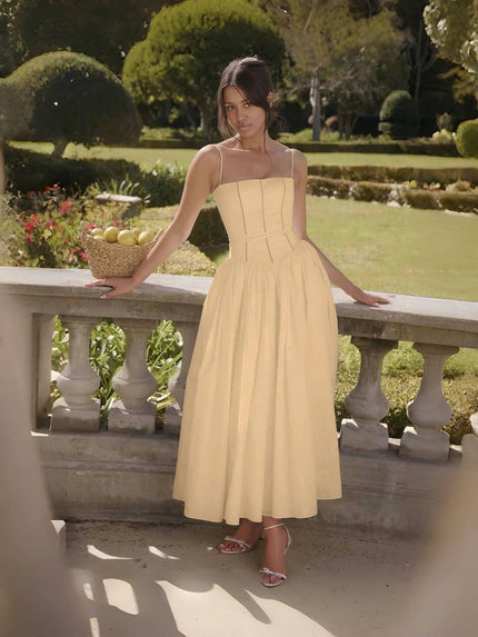 Tan midi dress with thin straps, corset-style bodice and flared skirt