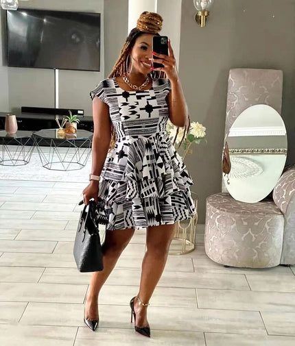 Geometric mini dress with tiered flared skirt, sleeveless black-and-white print