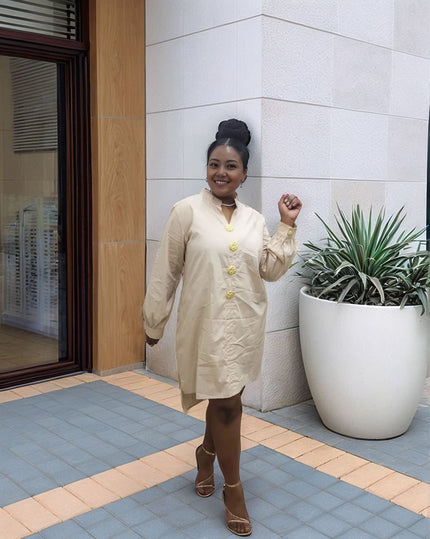 Nude midi dress with five gold buttons at the front and long sleeves