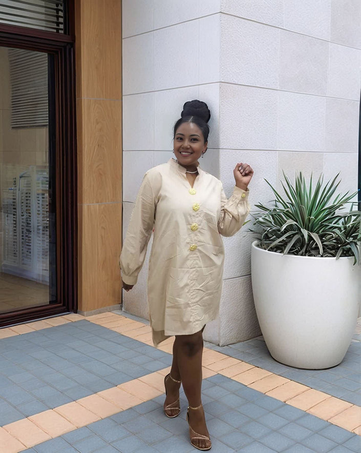 Nude midi dress with five gold buttons at the front and long sleeves