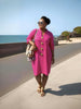 Hot-pink midi dress with five gold button placket and long sleeves