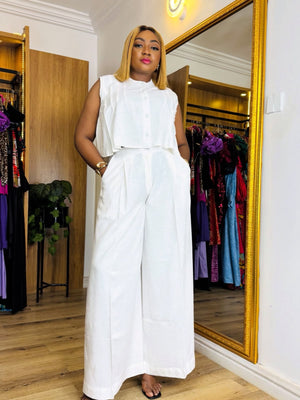 Women's white sleeveless crop top and wide-leg trousers set with ruffled top