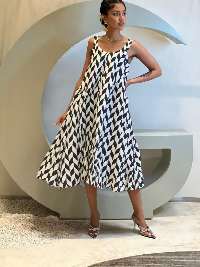 Geometric midi dress with black and white diamond pattern, sleeveless A-line fit