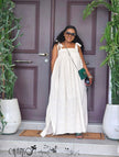 Off-white eyelet maxi dress with bow tie shoulder straps and wide skirt