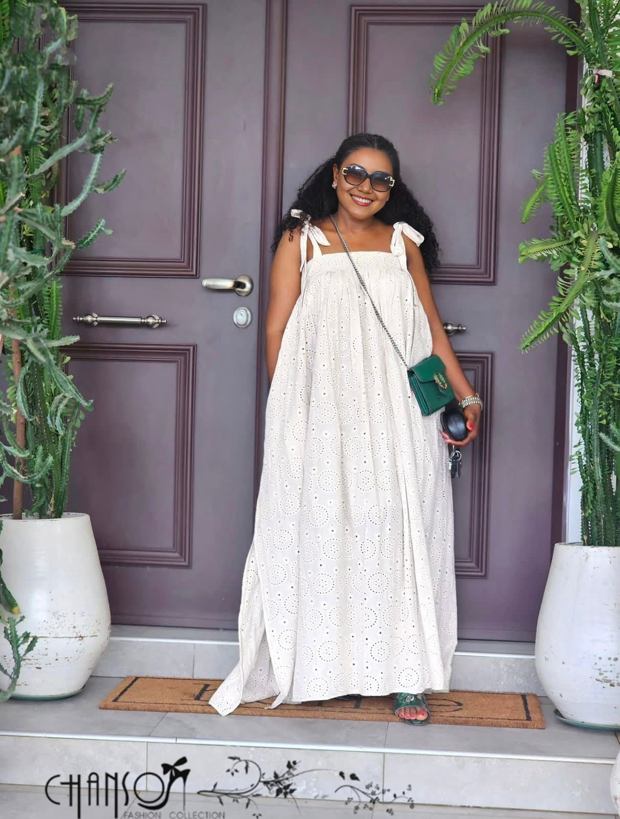 Off-white eyelet maxi dress with bow tie shoulder straps and wide skirt