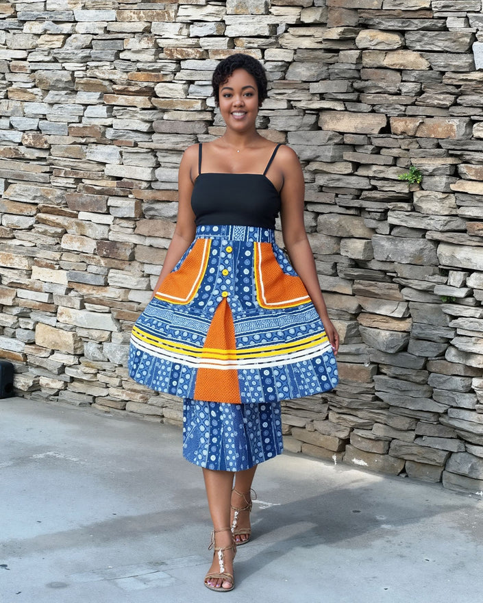 Layered three-piece skirt set with black spaghetti-strap top and blue patterned skirt