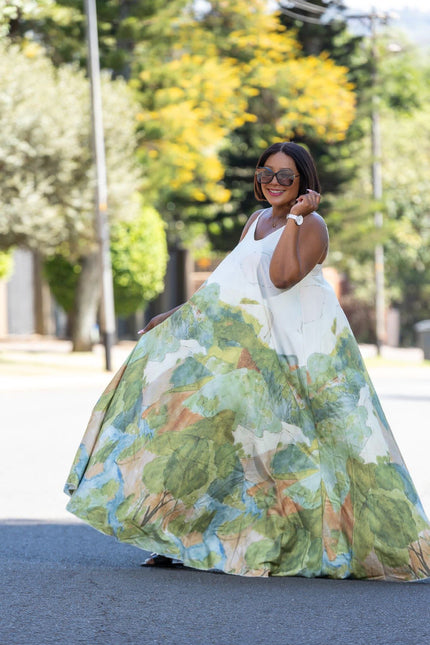 Sleeveless maxi dress with green, blue, and tan print skirt and white bodice