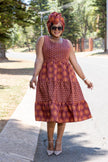 Sleeveless tiered ethnic dress in burgundy with orange geometric motifs