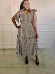 Sleeveless ruffle midi dress with wavy black-and-white pattern and high neckline