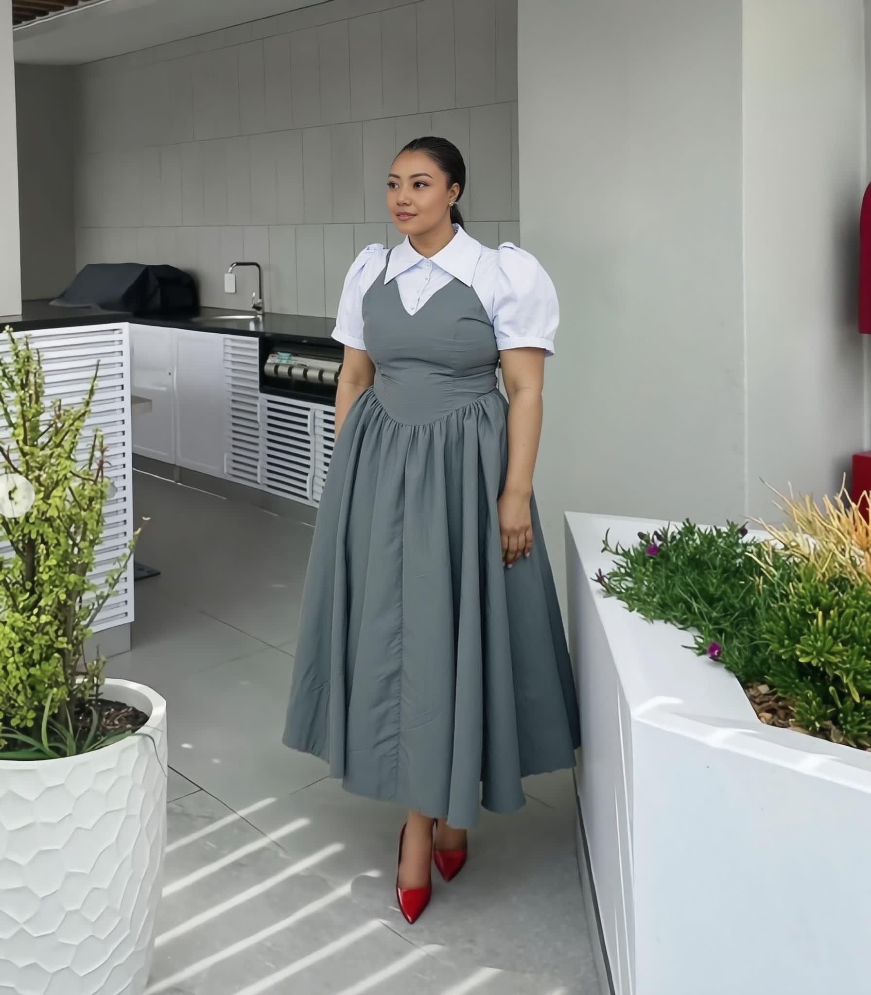 Gray pleated midi dress with puff sleeves, white collar, and cinched waist