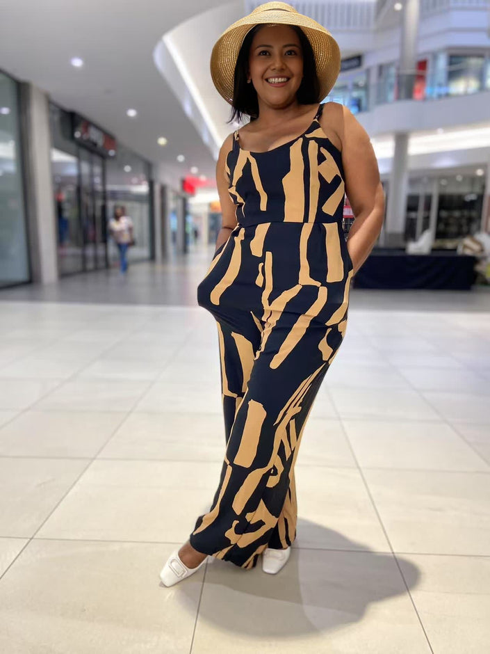 Sleeveless wide-leg jumpsuit, navy base with tan abstract stripe print