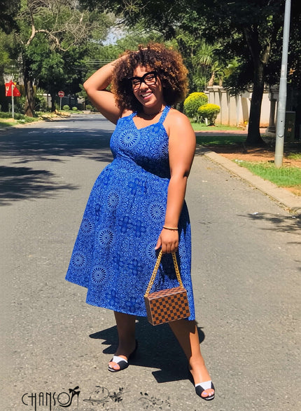 Blue halter midi fit-and-flare dress with geometric floral print, sleeveless.