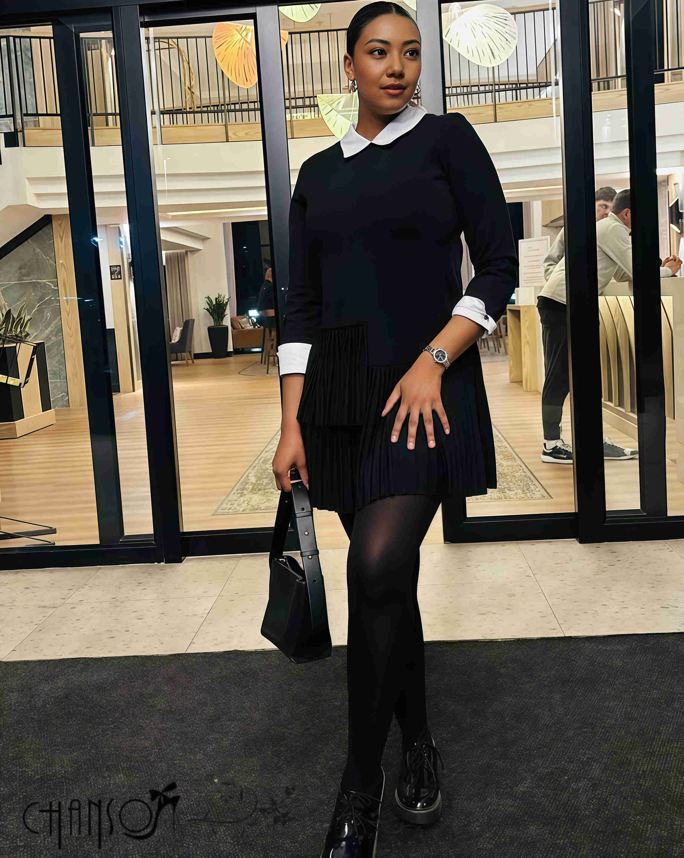 Black pleated midi dress with contrast white collar, long sleeves, and pleated hem