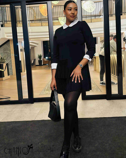 Black pleated midi dress with contrast white collar, long sleeves, and pleated hem