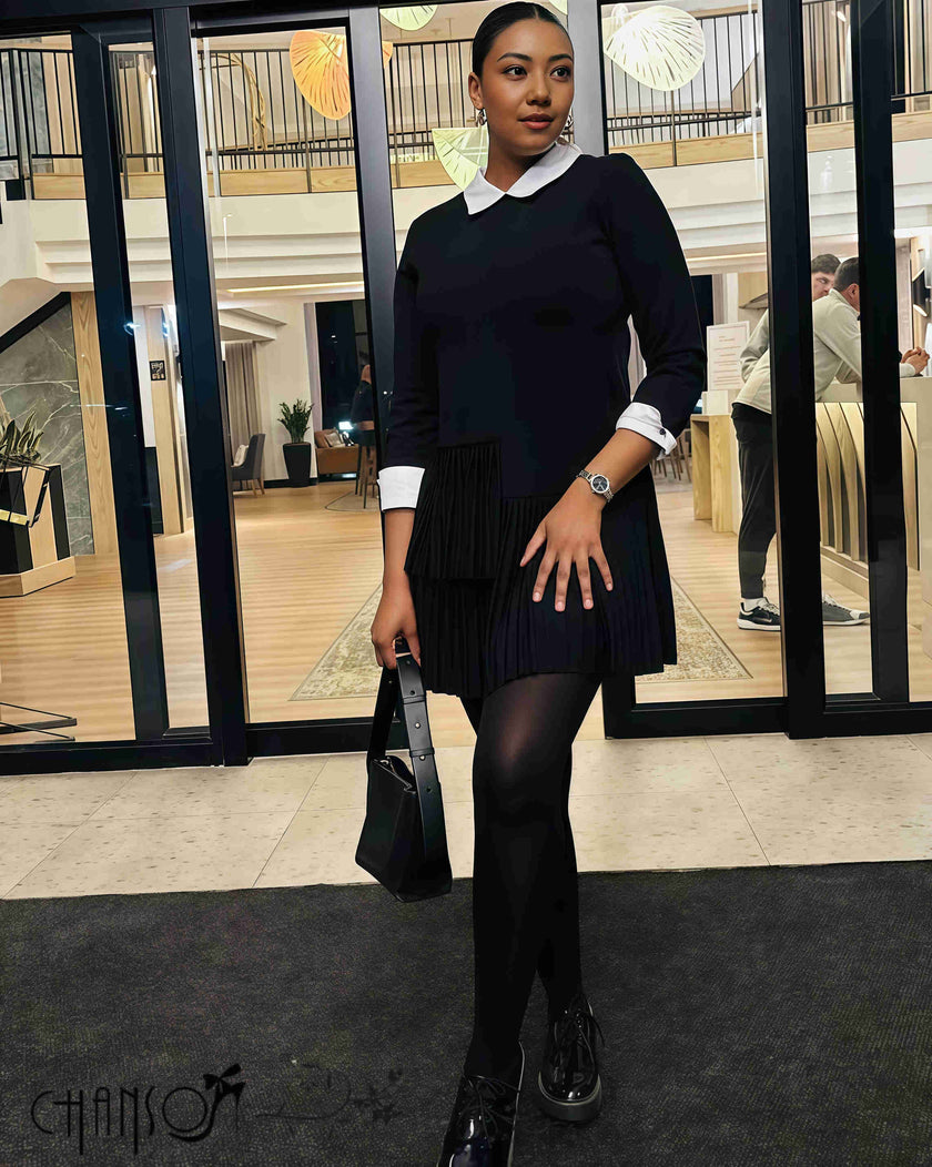 Black pleated midi dress with contrast white collar, long sleeves, and pleated hem