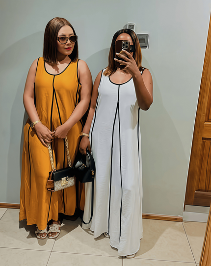 Sleeveless A-line maxi dresses, one goldenrod and one white, with black trim lines