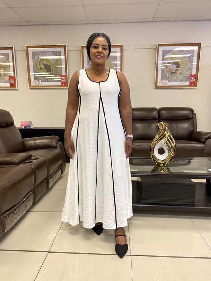 White sleeveless A-line maxi dress with black-trim vertical seam detail