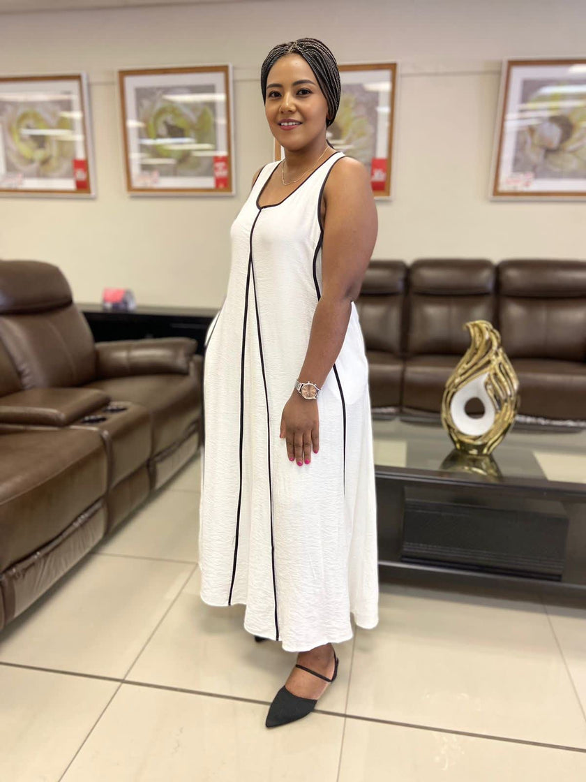 White sleeveless A-line maxi dress with black-trim vertical seam detail