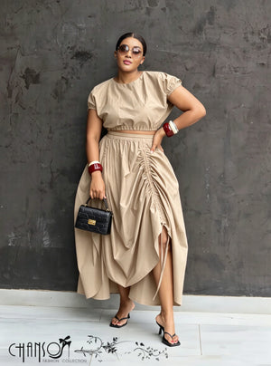 Nude ruched maxi skirt with adjustable waist, draped folds and side slit