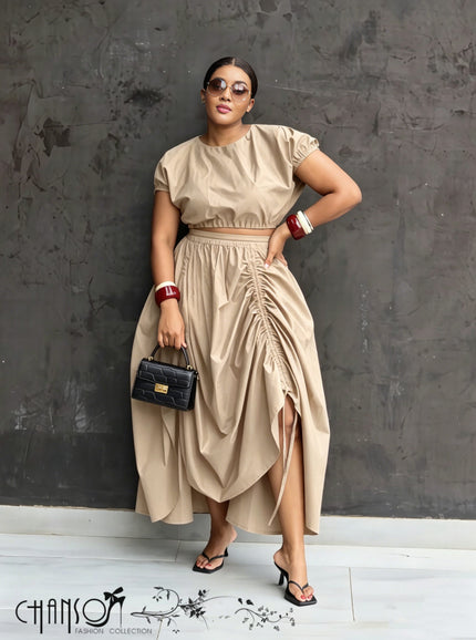 Nude ruched maxi skirt with gathered waist and draped, side-slit hem