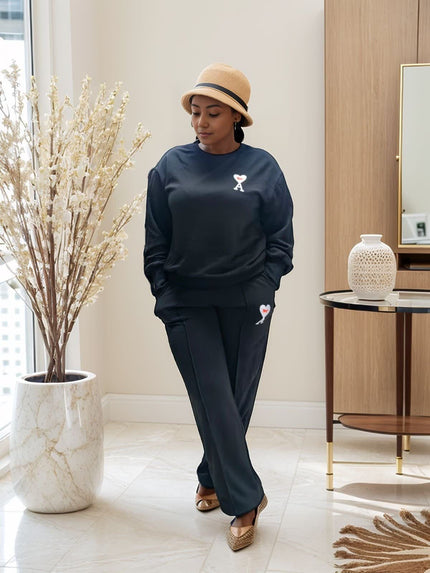 Black loose-fit jogger set with sweatshirt and joggers, embroidered cat logo on chest